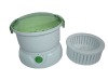 Home electrical potato peeler with green lid and salad spinner